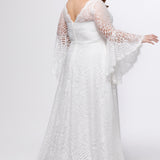 Boho crochet lace plus size wedding dress with V-neckline, illusion lace straps, illusion long flowy bell sleeves, natural wiasltine and slim A-line skirt finished with scalloped eyelash hem.  Available in ivory. Celebrations by Sydney's Closet style CE2604