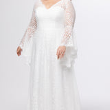 Boho crochet lace plus size wedding dress with V-neckline, illusion lace straps, illusion long flowy bell sleeves, natural wiasltine and slim A-line skirt finished with scalloped eyelash hem.  Available in ivory. Celebrations by Sydney's Closet style CE2604