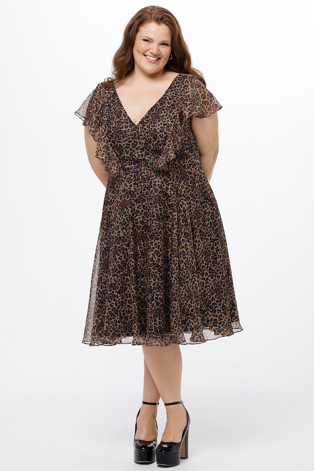 Celebrations by Sydney's Closet style CE2605 in animal print. 

Knee length plus size animal print dress.  V-neck, short flutter sleeves, natural waistline, pockets and ruffles on bodice princess seams. Made from printed chiffon and light satin lining. Center back zipper. 
