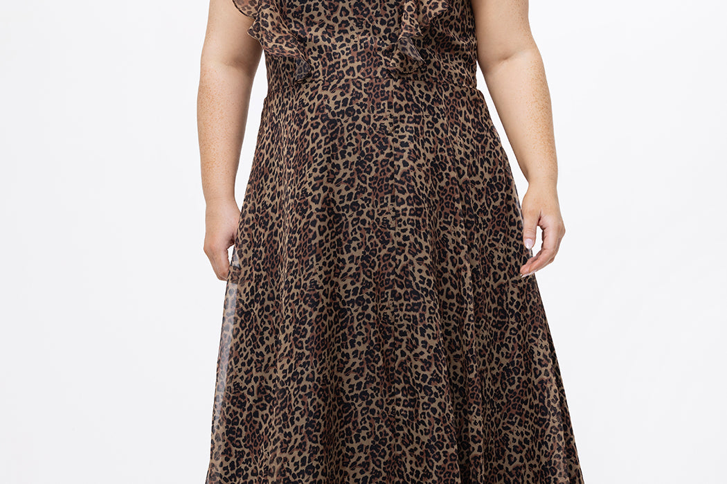 Plus size A-line floor length animal print gown. Flutter cap sleeves, ruffle starting at highpoint of shoulder down to natural waistline. Left leg slit and center back zipper.  CE2606 available in sizes 14-32 in animal print. Celebrations by Sydney's Closet.