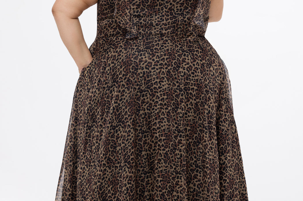 Plus size A-line floor length animal print gown. Flutter cap sleeves, ruffle starting at highpoint of shoulder down to natural waistline. Left leg slit and center back zipper.  CE2606 available in sizes 14-32 in animal print. Celebrations by Sydney's Closet.