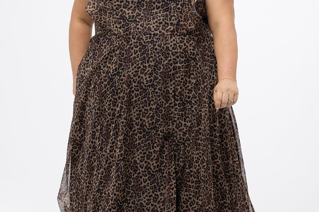 Plus size A-line floor length animal print gown. Flutter cap sleeves, ruffle starting at highpoint of shoulder down to natural waistline. Left leg slit and center back zipper.  CE2606 available in sizes 14-32 in animal print. Celebrations by Sydney's Closet.