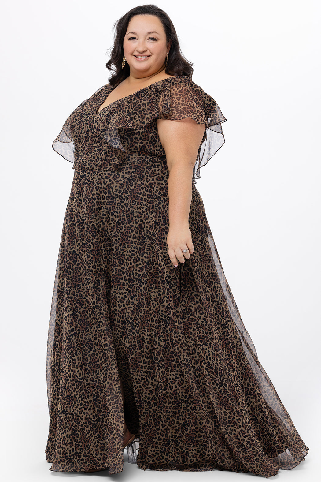 Celebrations by Sydney's Closet style CE2606 in animal print. 

Long plus size animal print dress.  V-neck, short flutter sleeves, natural waistline, pockets and ruffles on bodice princess seams. Left leg slit. Made from printed chiffon and light satin lining. High scoop back and center back zipper. 