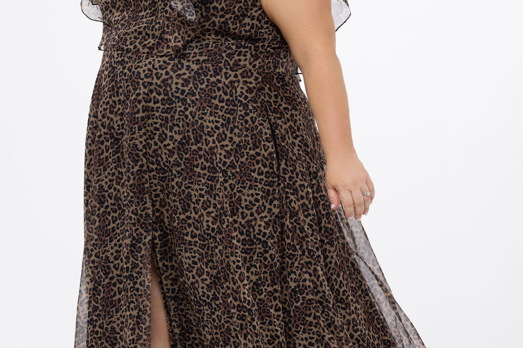 Plus size A-line floor length animal print gown. Flutter cap sleeves, ruffle starting at highpoint of shoulder down to natural waistline. Left leg slit and center back zipper.  CE2606 available in sizes 14-32 in animal print. Celebrations by Sydney's Closet.