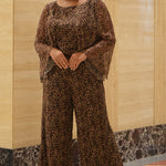 Plus size one-piece animal print jumpsuit. Long flowy chiffon sleeves and blouson bodice, elastic waist, and wide-leg pants. Center back zipper and scoop neckline. CE2607 available in sizes 14-28 in animal print. Celebration's by Sydney's Closet. 