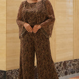 Plus size one-piece animal print jumpsuit. Long flowy chiffon sleeves and blouson bodice, elastic waist, and wide-leg pants. Center back zipper and scoop neckline. CE2607 available in sizes 14-28 in animal print. Celebration's by Sydney's Closet. 