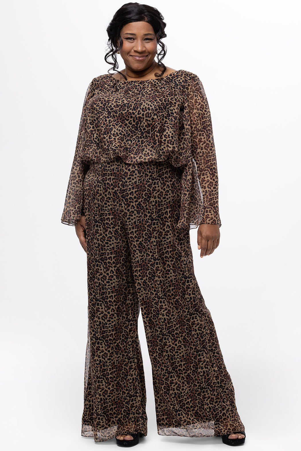 Plus size one-piece animal print jumpsuit. Long flowy chiffon sleeves and blouson bodice, elastic waist, and wide-leg pants. Center back zipper and scoop neckline. CE2607 available in sizes 14-28 in animal print. Celebration's by Sydney's Closet. 