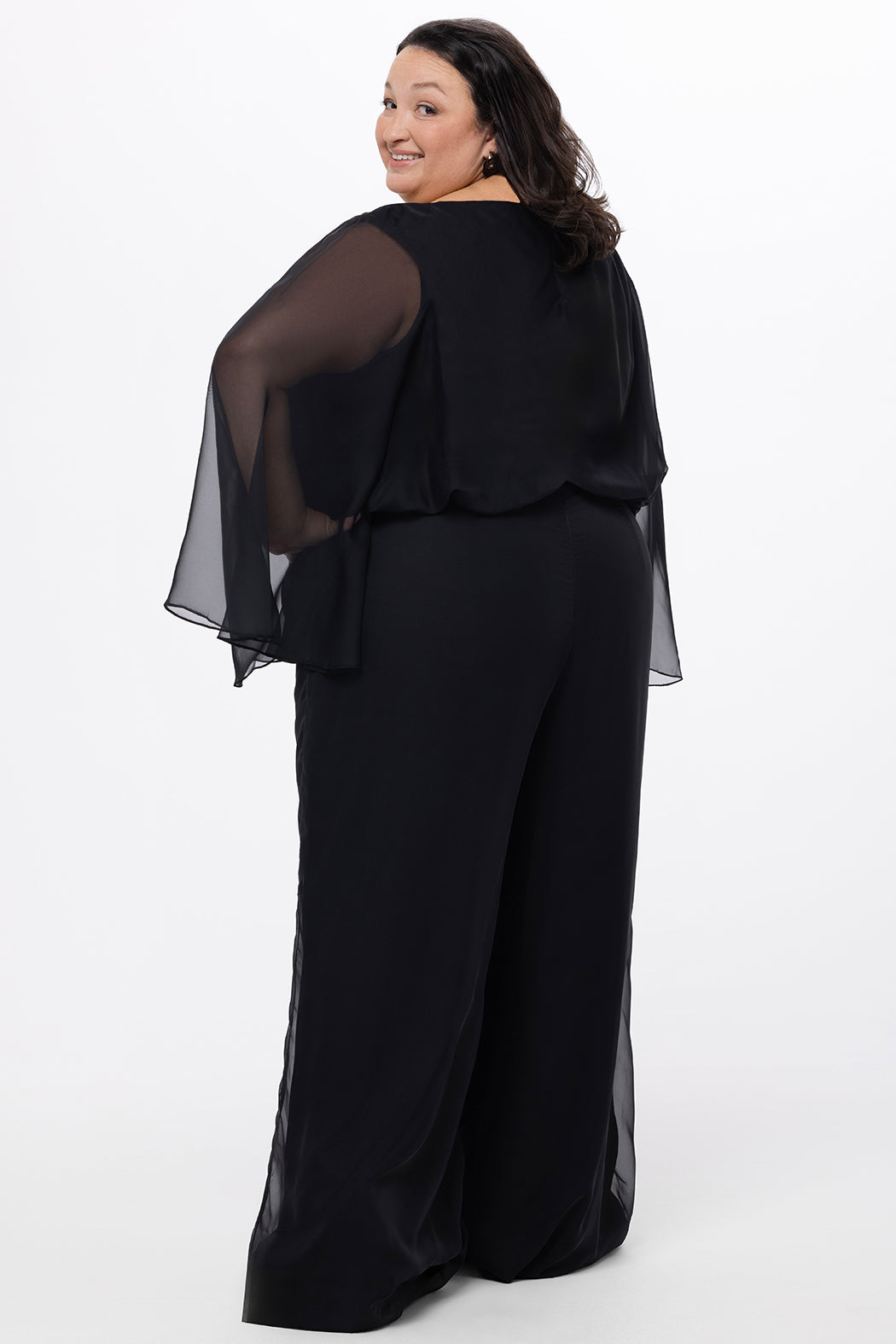 Celebration's by Sydney's Closet style CE2608 in black. 

Scoop neckline, long cape sleeve chiffon jumpsuit. Wide leg pants, blouson bodice and natural waistline. High scoop back with center back zipper. 