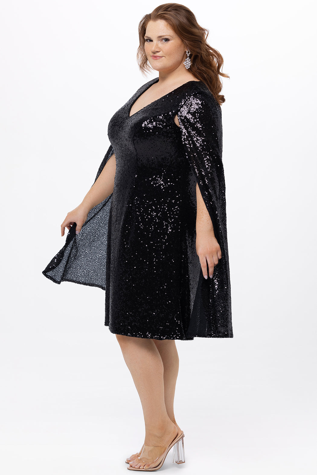 Sydney's Closet CE2609 in black.

Plus size sequin black short party dress. V-neckline, bra-friendly straps with attached cape sleeve detail, princess silhouette, slim A-line skirt. at knee-length.