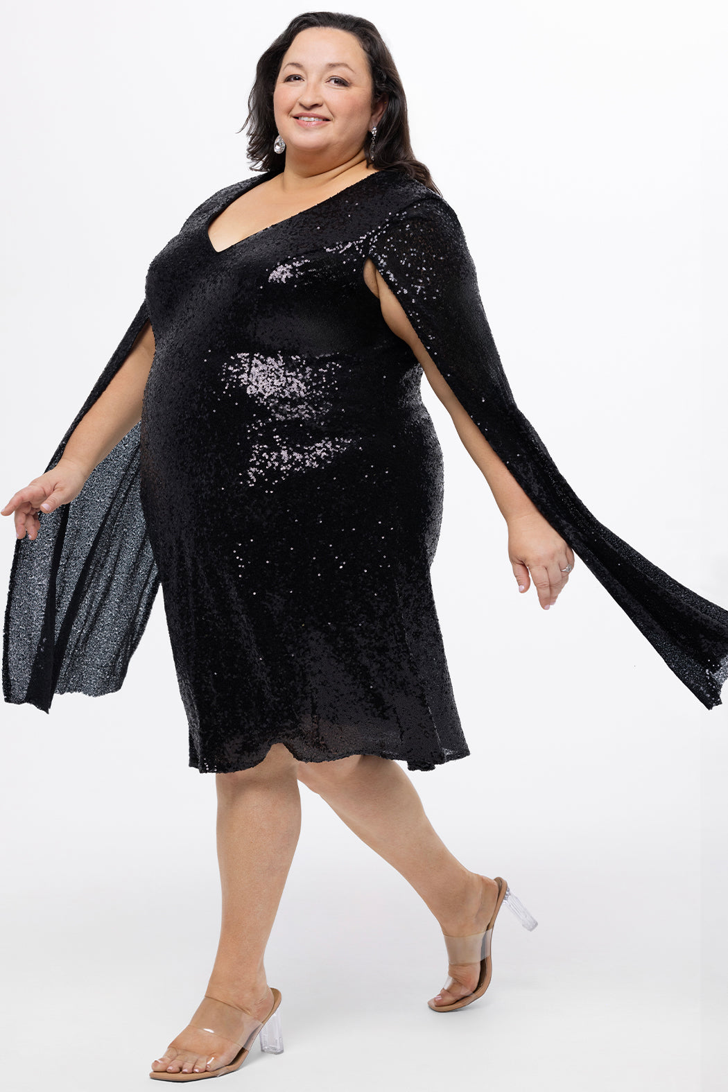 Sydney's Closet CE2609 in black.

Plus size sequin black short party dress. V-neckline, bra-friendly straps with attached cape sleeve detail, princess silhouette, slim A-line skirt. at knee-length.