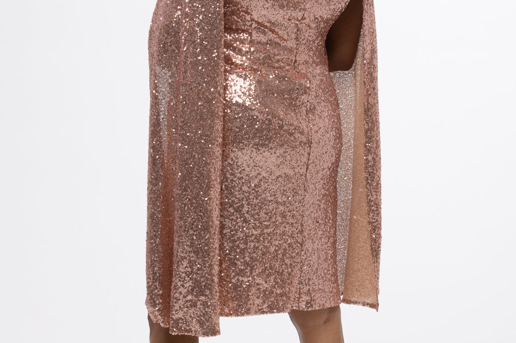 Sydney's Closet CE2609 in rose gold.

Plus size sequin rose gold metallic short party dress. V-neckline, bra-friendly straps with attached cape sleeve detail, princess silhouette, slim A-line skirt. at knee-length.