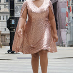 Sydney's Closet CE2609 in rose gold.

Plus size sequin rose gold metallic short party dress. V-neckline, bra-friendly straps with attached cape sleeve detail, princess silhouette, slim A-line skirt. at knee-length.