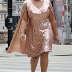 Sydney's Closet CE2609 in rose gold.

Plus size sequin rose gold metallic short party dress. V-neckline, bra-friendly straps with attached cape sleeve detail, princess silhouette, slim A-line skirt. at knee-length.