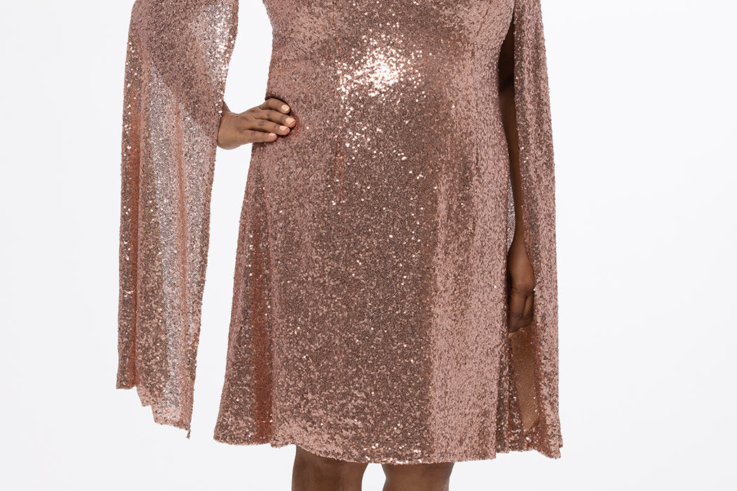 Sydney's Closet CE2609 in rose gold.

Plus size sequin rose gold metallic short party dress. V-neckline, bra-friendly straps with attached cape sleeve detail, princess silhouette, slim A-line skirt. at knee-length.