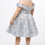 Celebrations by Sydney's Closet CE2610 in Light Blue Floral. 

Plus size knee-length party dress in metallic light blue floral brocde print. Off-the-shoulder neckline, natural waistline and A-line skirt with pockets. 