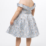 Celebrations by Sydney's Closet CE2610 in Light Blue Floral. 

Plus size knee-length party dress in metallic light blue floral brocde print. Off-the-shoulder neckline, natural waistline and A-line skirt with pockets. 