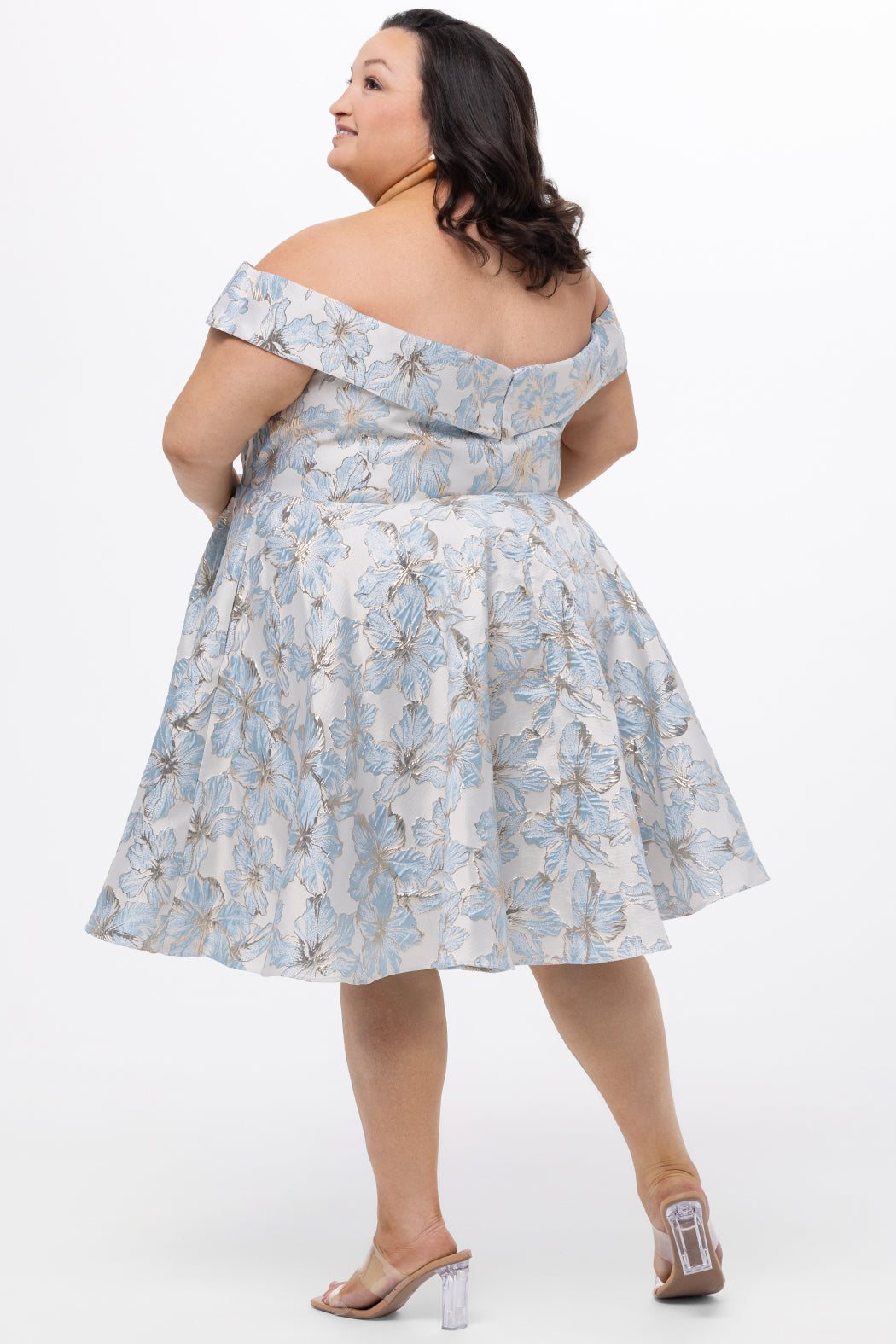 Celebrations by Sydney's Closet CE2610 in Light Blue Floral. 

Plus size knee-length party dress in metallic light blue floral brocde print. Off-the-shoulder neckline, natural waistline and A-line skirt with pockets. 