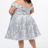 Celebrations by Sydney's Closet CE2610 in Light Blue Floral. 

Plus size knee-length party dress in metallic light blue floral brocde print. Off-the-shoulder neckline, natural waistline and A-line skirt with pockets. 