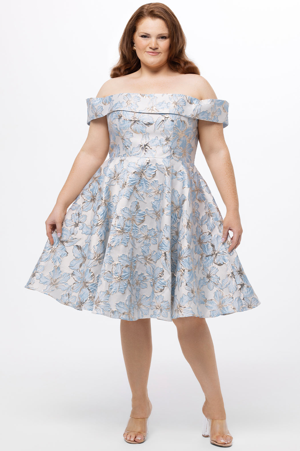 Celebrations by Sydney's Closet CE2610 in Light Blue Floral. 

Plus size knee-length party dress in metallic light blue floral brocde print. Off-the-shoulder neckline, natural waistline and A-line skirt with pockets. 