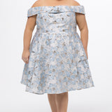 Celebrations by Sydney's Closet CE2610 in Light Blue Floral. 

Plus size knee-length party dress in metallic light blue floral brocde print. Off-the-shoulder neckline, natural waistline and A-line skirt with pockets. 