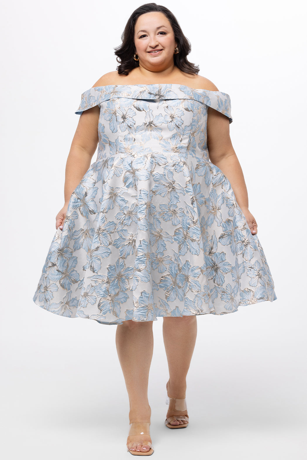 Celebrations by Sydney's Closet CE2610 in Light Blue Floral. 

Plus size knee-length party dress in metallic light blue floral brocde print. Off-the-shoulder neckline, natural waistline and A-line skirt with pockets. 