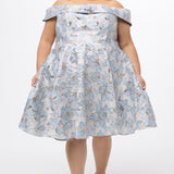 Celebrations by Sydney's Closet CE2610 in Light Blue Floral. 

Plus size knee-length party dress in metallic light blue floral brocde print. Off-the-shoulder neckline, natural waistline and A-line skirt with pockets. 