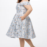 Celebrations by Sydney's Closet CE2610 in Light Blue Floral. 

Plus size knee-length party dress in metallic light blue floral brocde print. Off-the-shoulder neckline, natural waistline and A-line skirt with pockets. 