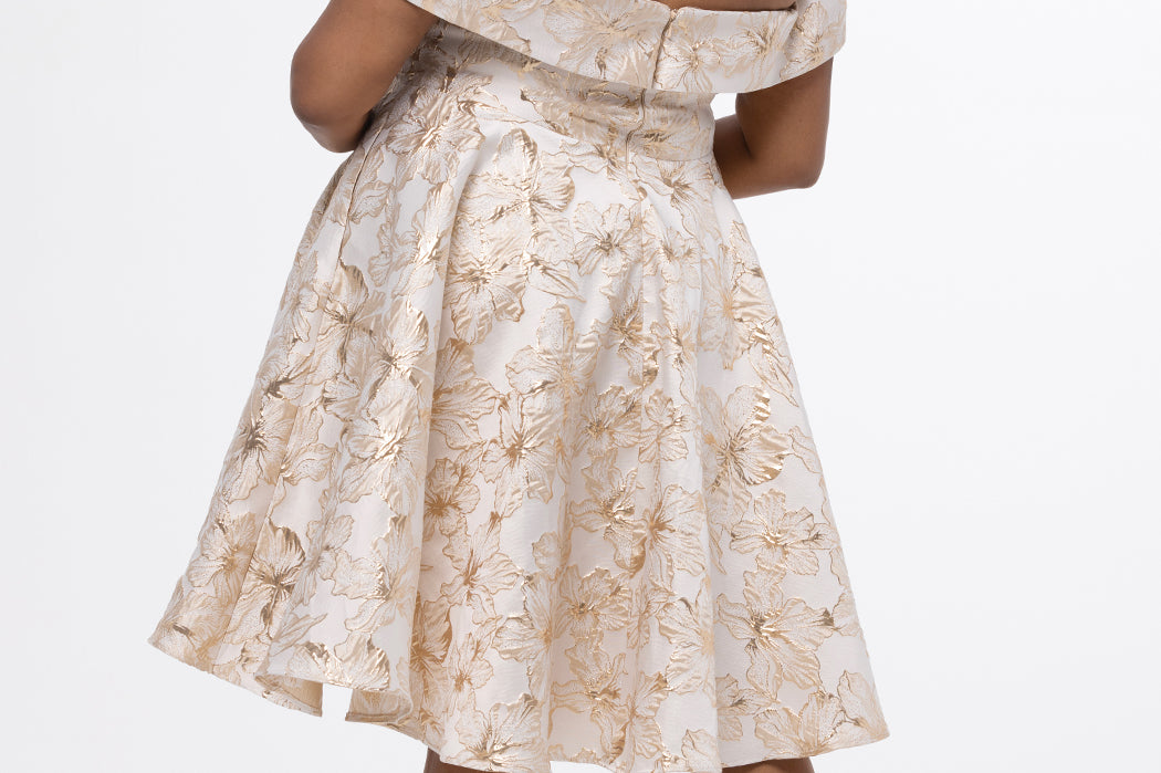 Celebrations by Sydney's Closet CE2610 in Gold Floral. 

Plus size knee-length party dress in metallic gold floral brocde print. Off-the-shoulder neckline, natural waistline and A-line skirt with pockets. 