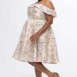 Celebrations by Sydney's Closet CE2610 in Gold Floral. 

Plus size knee-length party dress in metallic gold floral brocde print. Off-the-shoulder neckline, natural waistline and A-line skirt with pockets. 