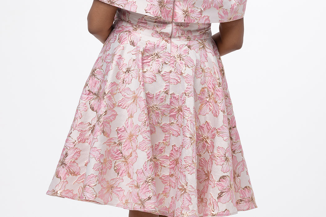 Celebrations by Sydney's Closet CE2610 in Light Pink Floral. 

Plus size knee-length party dress in metallic light pink floral brocde print. Off-the-shoulder neckline, natural waistline and A-line skirt with pockets. 