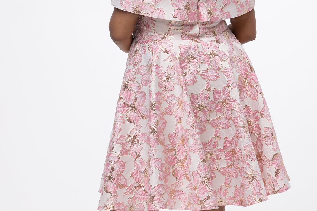 Celebrations by Sydney's Closet CE2610 in Light Pink Floral. 

Plus size knee-length party dress in metallic light pink floral brocde print. Off-the-shoulder neckline, natural waistline and A-line skirt with pockets. 