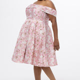 Celebrations by Sydney's Closet CE2610 in Light Pink Floral. 

Plus size knee-length party dress in metallic light pink floral brocde print. Off-the-shoulder neckline, natural waistline and A-line skirt with pockets. 