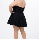 Celebrations by Sydney's Closet Style CE2612 in black. 

Plus size strapless black short mini party dress with sweetheart neckline, exposed corset boning on bustier bodice and mini skirt in all over stretch lace. 