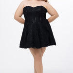 Celebrations by Sydney's Closet Style CE2612 in black. 

Plus size strapless black short mini party dress with sweetheart neckline, exposed corset boning on bustier bodice and mini skirt in all over stretch lace. 