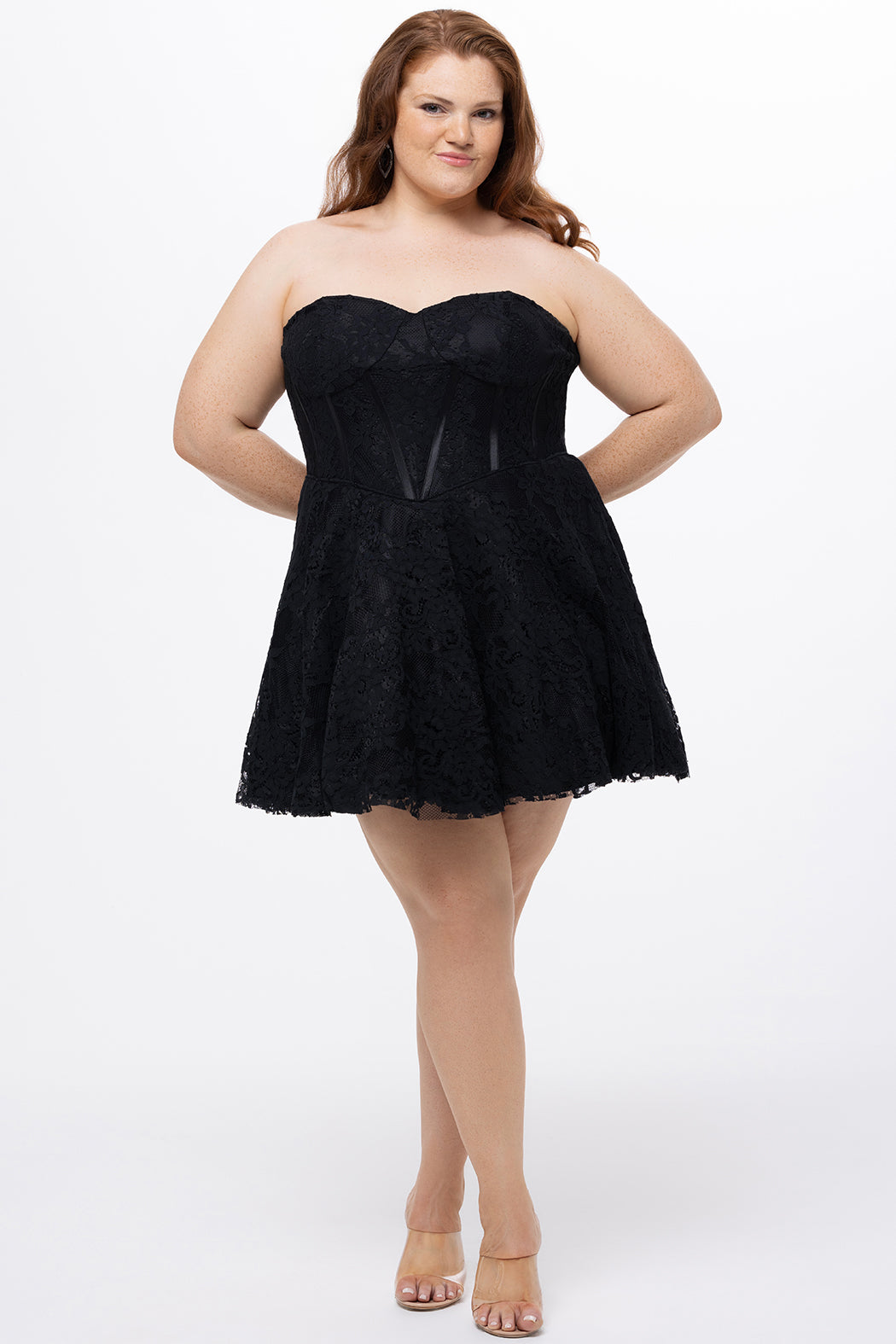 Celebrations by Sydney's Closet Style CE2612 in black. 

Plus size strapless black short mini party dress with sweetheart neckline, exposed corset boning on bustier bodice and mini skirt in all over stretch lace. 