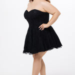 Celebrations by Sydney's Closet Style CE2612 in black. 

Plus size strapless black short mini party dress with sweetheart neckline, exposed corset boning on bustier bodice and mini skirt in all over stretch lace. 