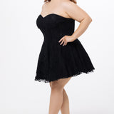 Celebrations by Sydney's Closet Style CE2612 in black. 

Plus size strapless black short mini party dress with sweetheart neckline, exposed corset boning on bustier bodice and mini skirt in all over stretch lace. 