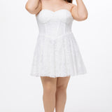 Celebrations by Sydney's Closet Style CE2612 in white. 

Plus size strapless white short mini party dress with sweetheart neckline, exposed corset boning on bustier bodice and mini skirt in all over stretch lace. 