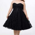 Celebrations by Sydney's Closet Style CE2613 in black. 

Plus size strapless black tea-length dress with sweetheart neckline, exposed corset boning on bustier bodice and tea-length skirt in all over stretch lace. 