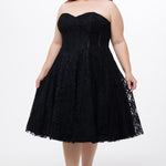Celebrations by Sydney's Closet Style CE2613 in black. 

Plus size strapless black tea-length dress with sweetheart neckline, exposed corset boning on bustier bodice and tea-length skirt in all over stretch lace. 