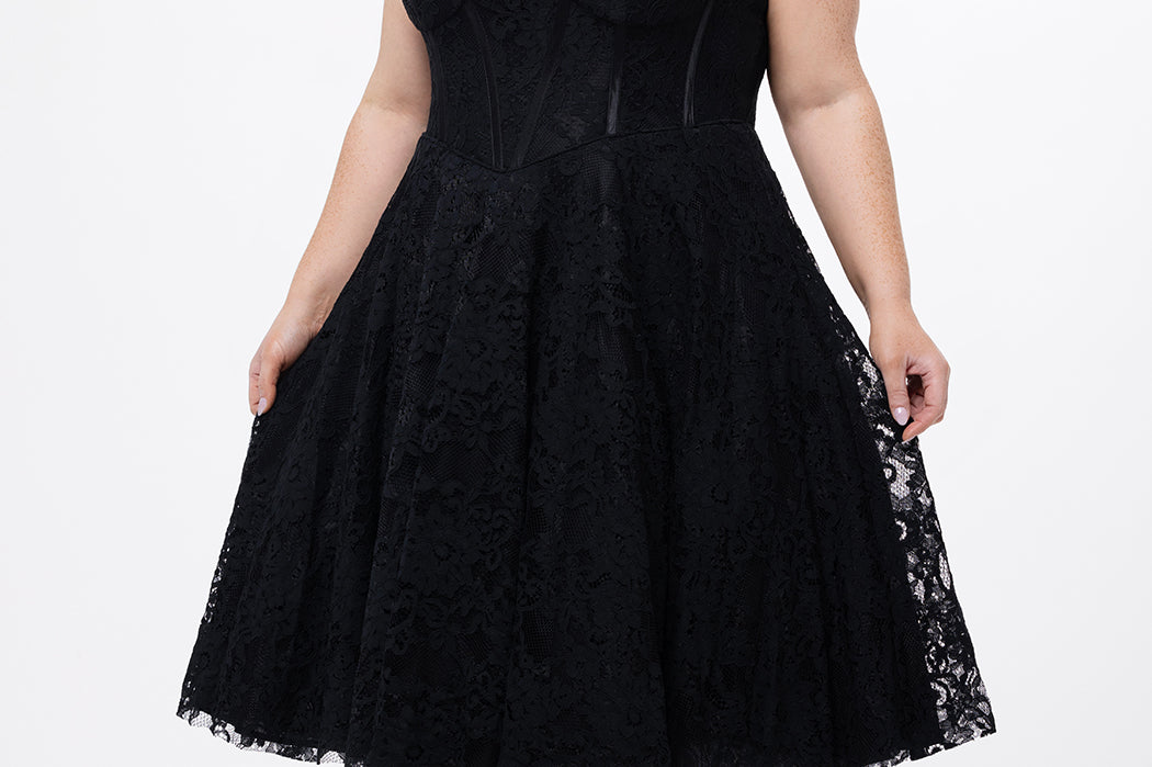 Celebrations by Sydney's Closet Style CE2613 in black. 

Plus size strapless black tea-length dress with sweetheart neckline, exposed corset boning on bustier bodice and tea-length skirt in all over stretch lace. 