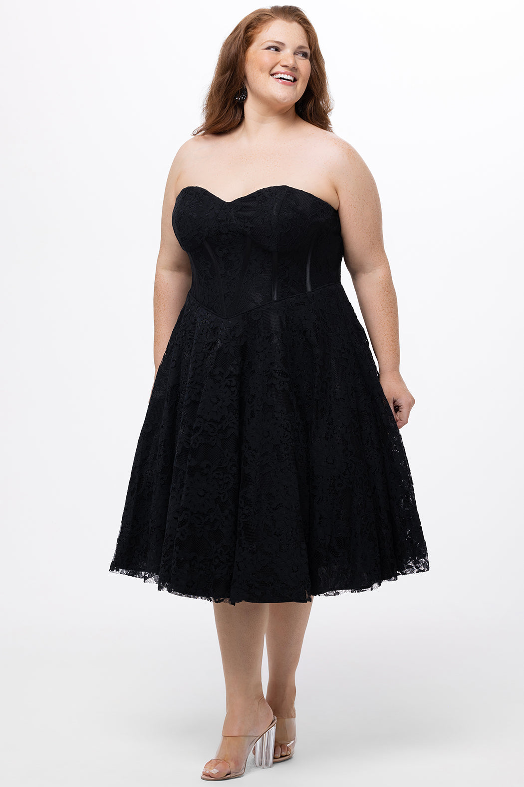 Celebrations by Sydney's Closet Style CE2613 in black. 

Plus size strapless black tea-length dress with sweetheart neckline, exposed corset boning on bustier bodice and tea-length skirt in all over stretch lace. 