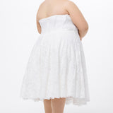 Celebrations by Sydney's Closet Style CE2613 in white. 

Plus size strapless white tea-length dress with sweetheart neckline, exposed corset boning on bustier bodice and tea-length skirt in all over stretch lace. 