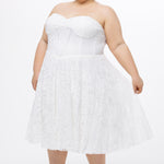 Celebrations by Sydney's Closet Style CE2613 in white. 

Plus size strapless white tea-length dress with sweetheart neckline, exposed corset boning on bustier bodice and tea-length skirt in all over stretch lace. 