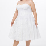 Celebrations by Sydney's Closet Style CE2613 in white. 

Plus size strapless white tea-length dress with sweetheart neckline, exposed corset boning on bustier bodice and tea-length skirt in all over stretch lace. 