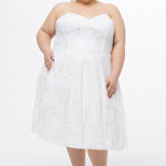Celebrations by Sydney's Closet Style CE2613 in white. 

Plus size strapless white tea-length dress with sweetheart neckline, exposed corset boning on bustier bodice and tea-length skirt in all over stretch lace. 
