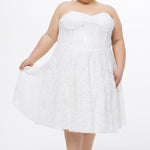 Celebrations by Sydney's Closet Style CE2613 in white. 

Plus size strapless white tea-length dress with sweetheart neckline, exposed corset boning on bustier bodice and tea-length skirt in all over stretch lace. 