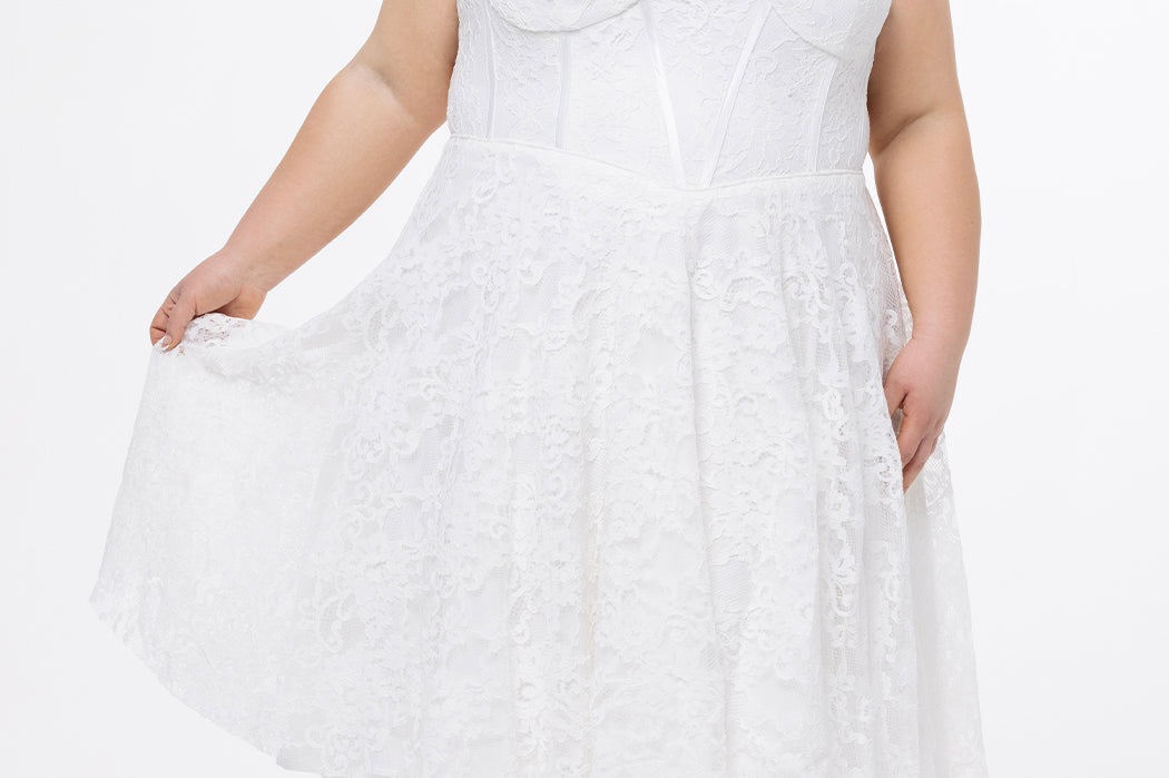 Celebrations by Sydney's Closet Style CE2613 in white. 

Plus size strapless white tea-length dress with sweetheart neckline, exposed corset boning on bustier bodice and tea-length skirt in all over stretch lace. 