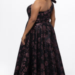 Celebrations by Sydney's Closet Style CE2614 in Pink Rose and Black floral brocade fabric.

Plus size maxi length formal dress. One-shoulder neckline with detachable bow at high point of shoulder, natural waistline and A-line skirt with pockets. 