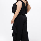 Celebrations by Sydney's Closet Style CE2615 in Black.

One-piece crepe satin jumpsuit with ruffled on outer pants seams. Bra-friendly straps, blouson bodice and wide leg pants. Center back zipper and scoop neckline. 